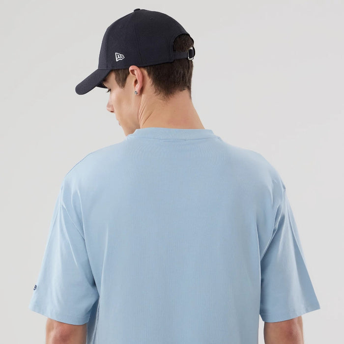 The model is wearing this MLB Food Graphic New York Yankees Oversized T-Shirt in pastel blue. 7