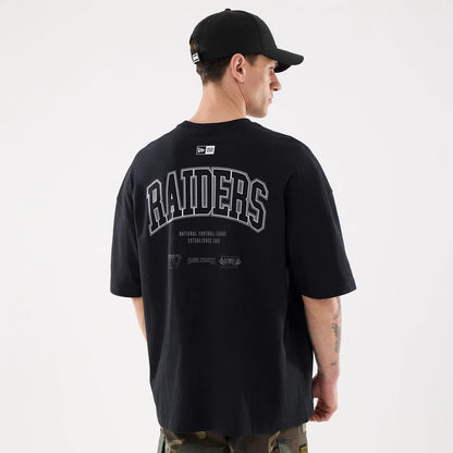 The model is wearing this NFL Raiders Wear Las Vegas Raiders Oversized T-Shirt in black. 2