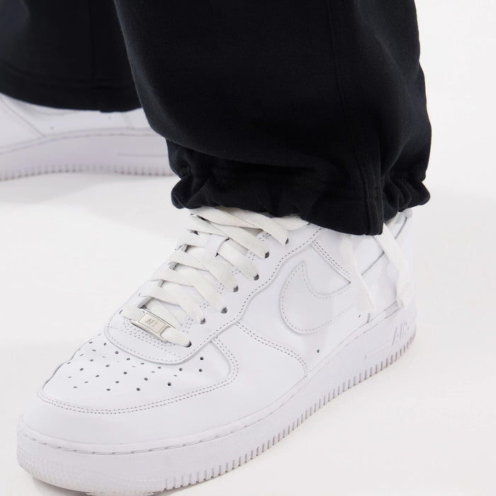 The model is wearing this New Era Straight Legged Joggers in black. 3