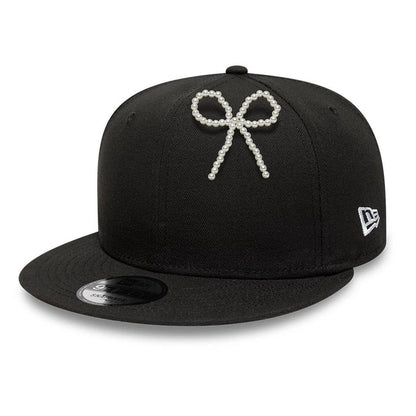 Pictured is this New Era Faux Pearl Bow Pin Badge in White. 2