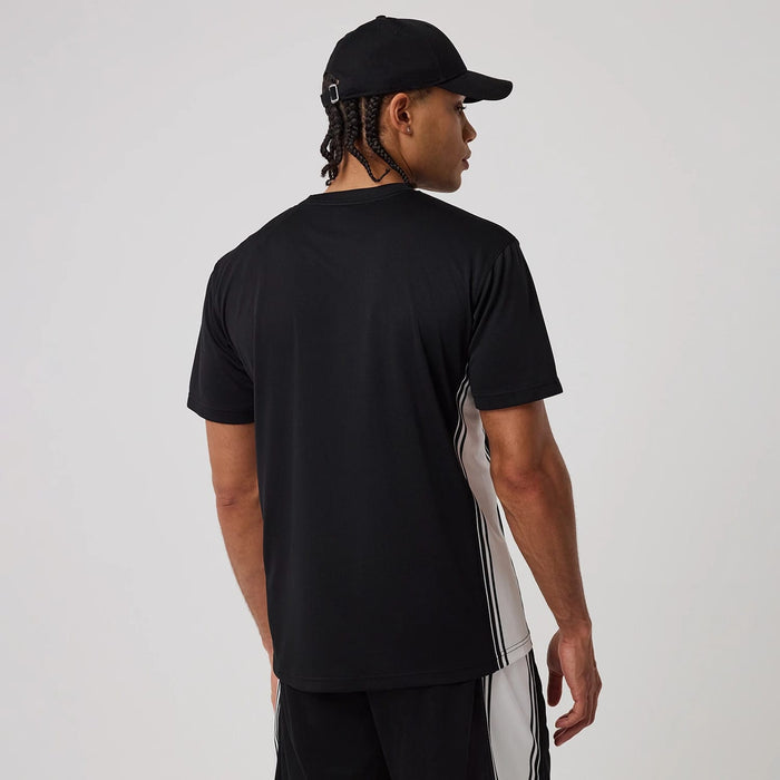 The model is wearing this New Era Mesh T-Shirt in black. 2