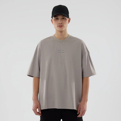 The model is wearing this New Era NEC Logo Oversized T-Shirt in Beige. 1
