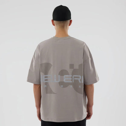 The model is wearing this New Era NEC Logo Oversized T-Shirt in Beige. 2