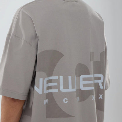 The model is wearing this New Era NEC Logo Oversized T-Shirt in Beige. 4