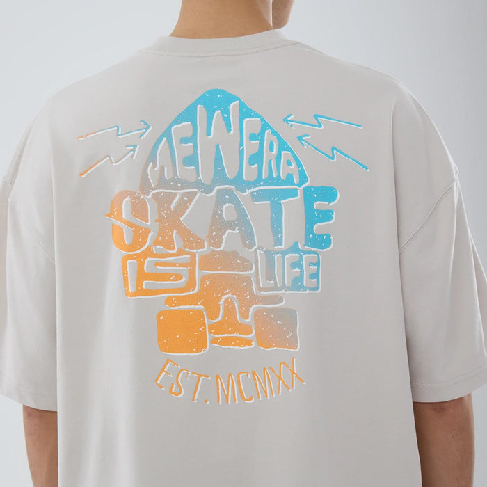 The model is wearing this New Era Skate Is Life Graphic Oversized T-Shirt in Cream. 4